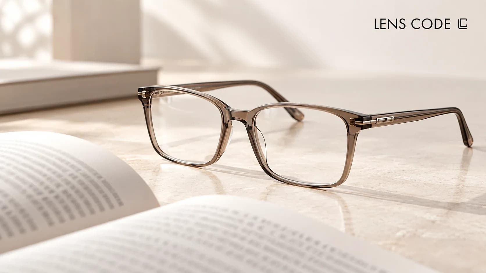 Reading glasses beside a book, phone and computer showing different viewing distances